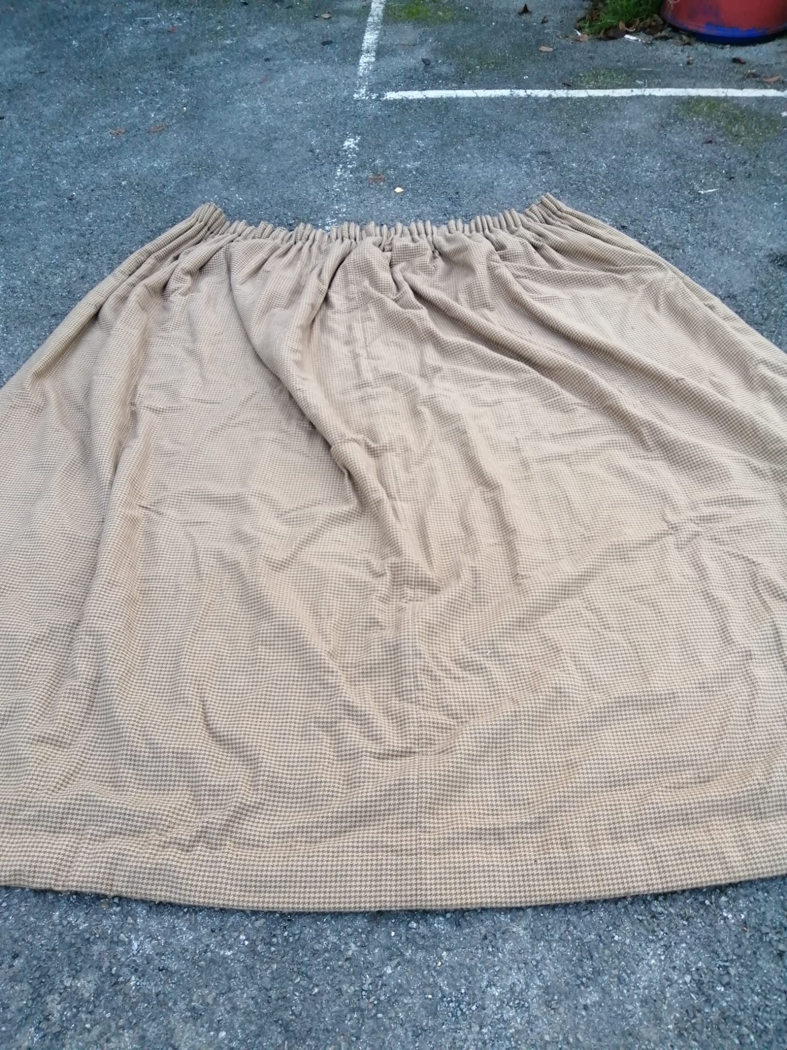 A pair of tweed curtains and two matching single curtains with a spare roll of material.